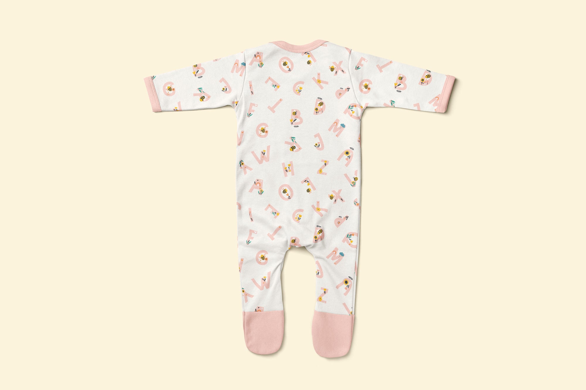 Back of baby rompersuit with pink alphabet pattern and pink accents