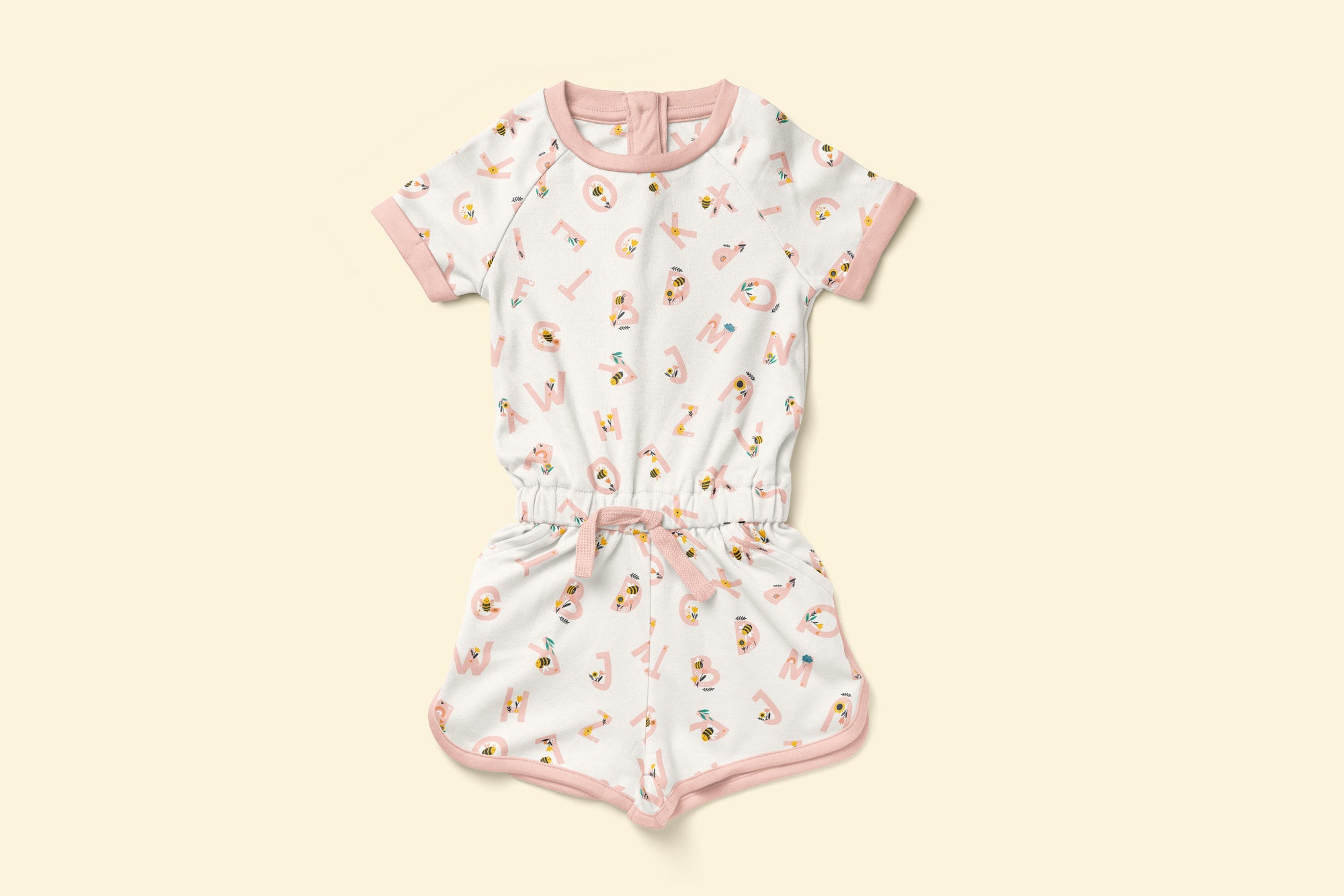 Cotton playsuit with pink alphabet pattern